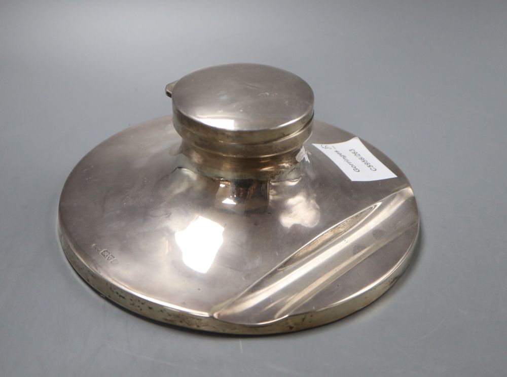 A George V silver capstan inkwell with pen rest, Chester 1915, loaded base, diameter 18cm